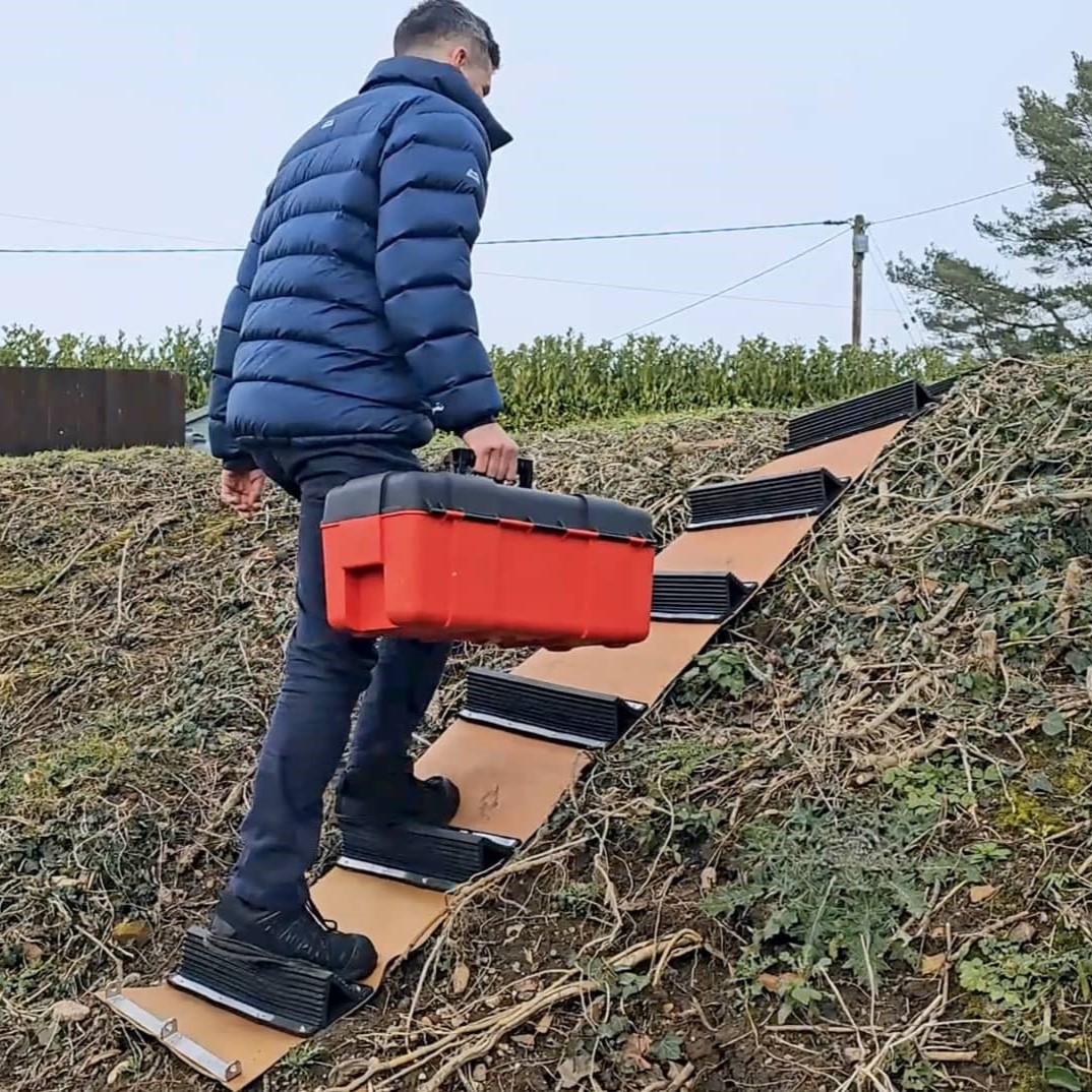 Person using the rollaway up verge with difficult terrain